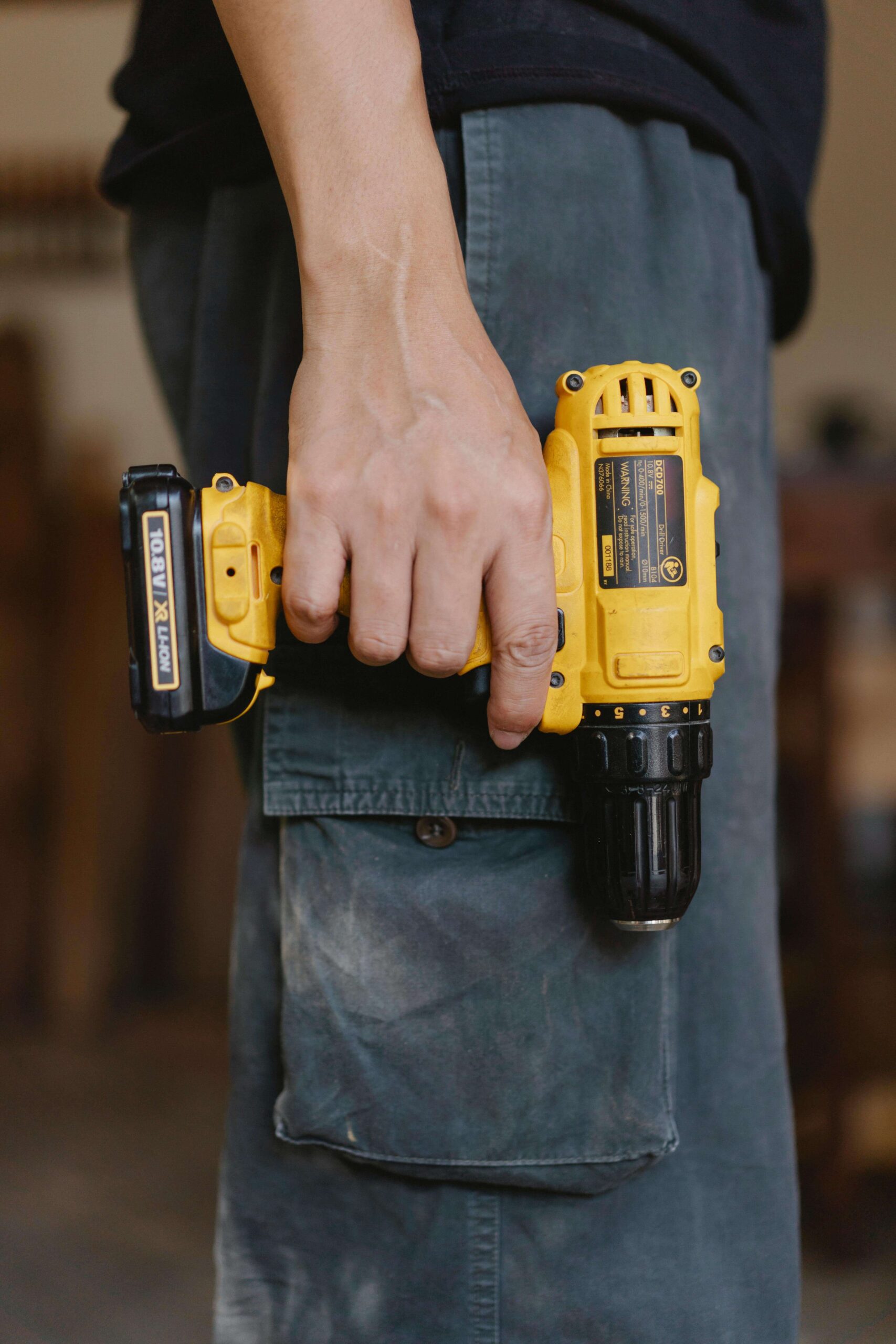 A handyman using tools to repair a broken faucet, representing home maintenance and repair services to keep your property in top condition.